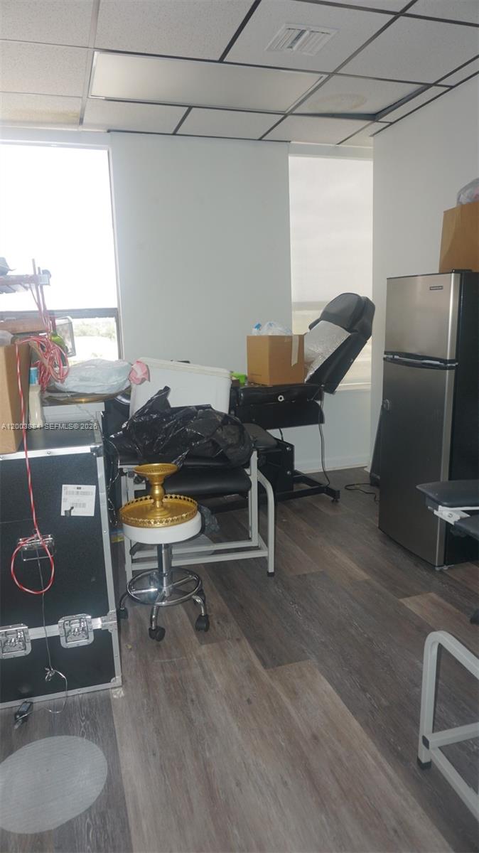 A small room features a tattoo chair, a rolling stool, and a stainless steel refrigerator — 1250 E Hallandale Beach Blvd, Hallandale Beach FL 33009, HALLANDALE BEACH, FL