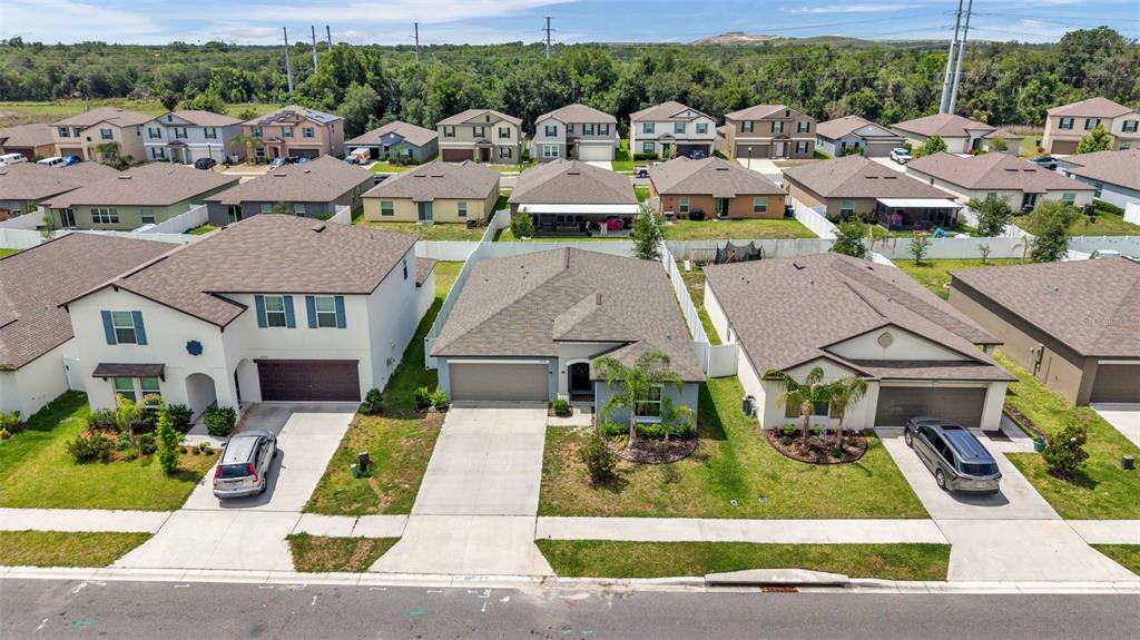 A single-story gray house with a two-car garage and two palm trees in the front yard — 2790 RED EGRET DRIVE, BARTOW, FL
