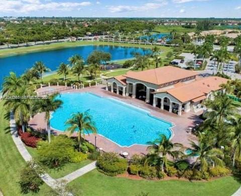 An aerial view shows a large swimming pool next to a clubhouse with a tiled roof — 22911 SW 88th Pl # 21, Cutler Bay FL 33190, CUTLER BAY, FL
