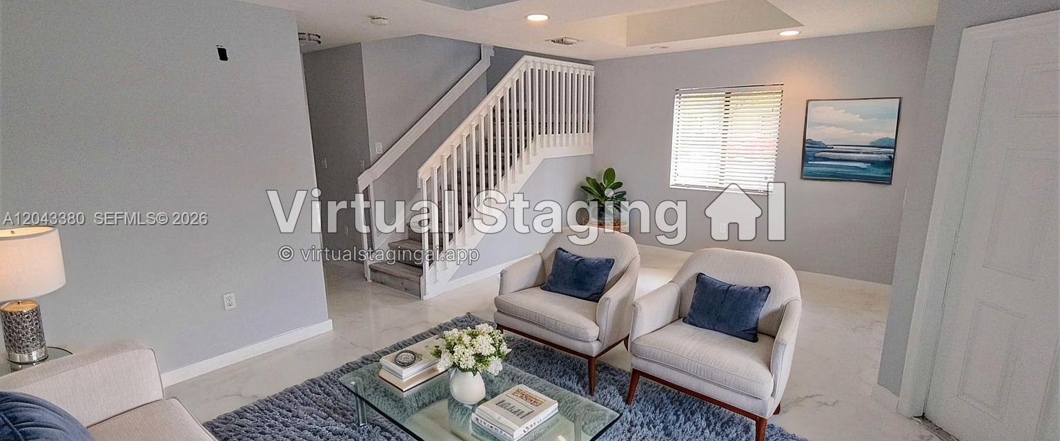 A living room features two armchairs, a glass coffee table, and a staircase — 22911 SW 88th Pl # 21, Cutler Bay FL 33190, CUTLER BAY, FL