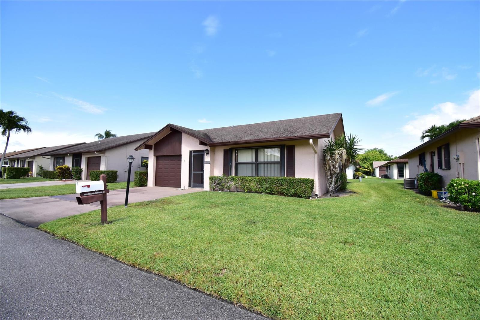 A single-story house with a brown garage, a front lawn, and a mailbox — 3305 Silver Buttonwood Drive, FL 33463, FL