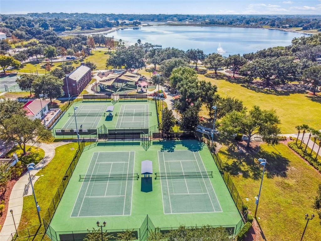 An aerial view of outdoor tennis courts next to a park and a lake — 518 INGLESIDE LANE, HAINES CITY, FL