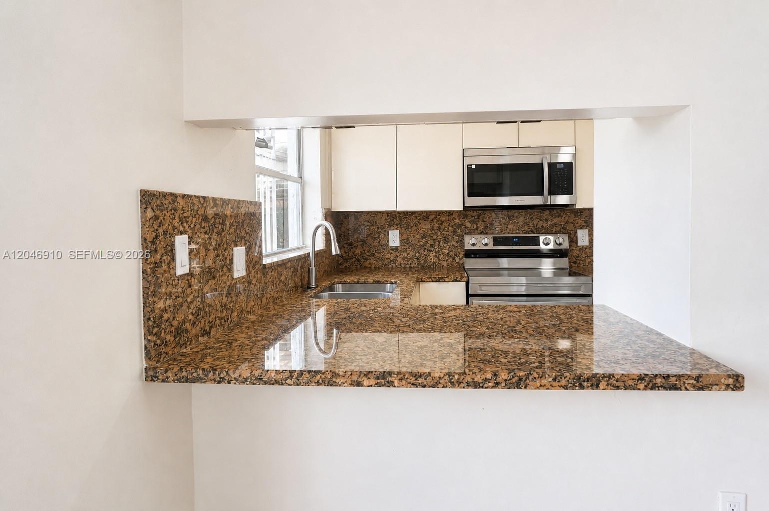 A kitchen features brown granite countertops, white cabinets, and stainless steel appliances — 1117 SW 104th Ct # 1117, Miami FL 33174, MIAMI, FL
