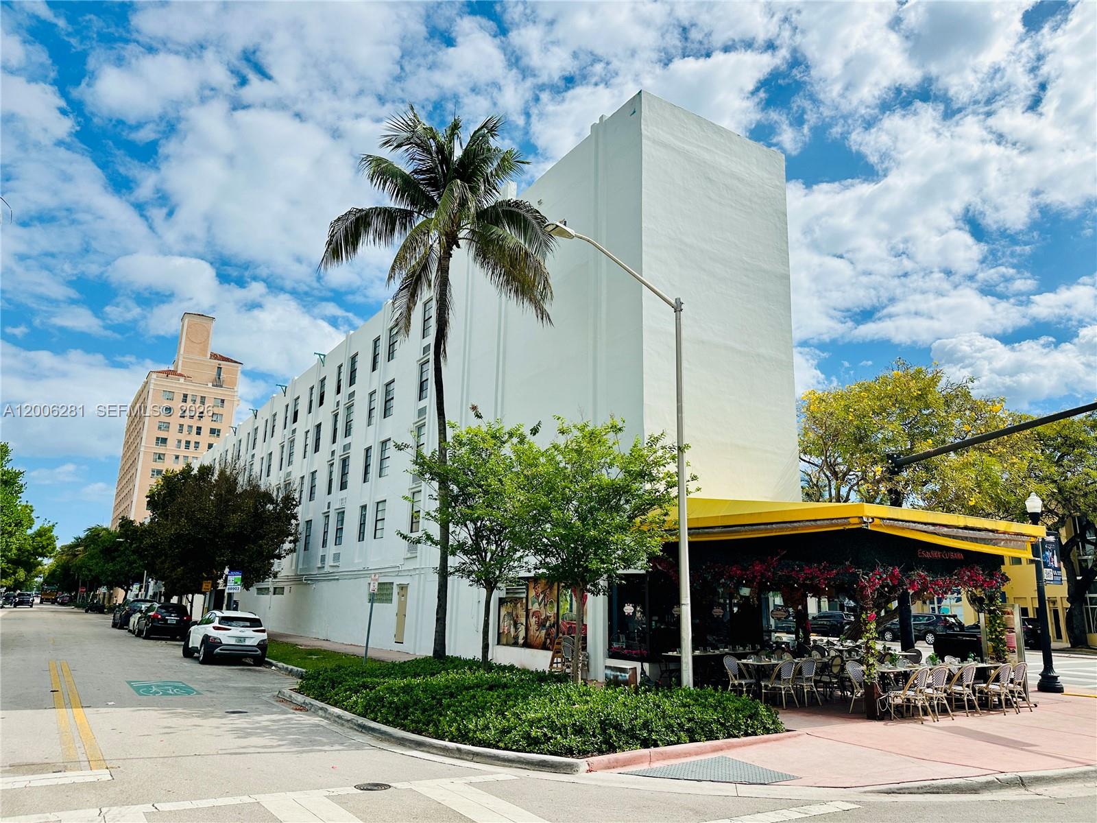 A white multi-story building with a palm tree and an outdoor restaurant patio — 710 Washington Ave # 321, Miami Beach FL 33139, MIAMI BEACH, FL