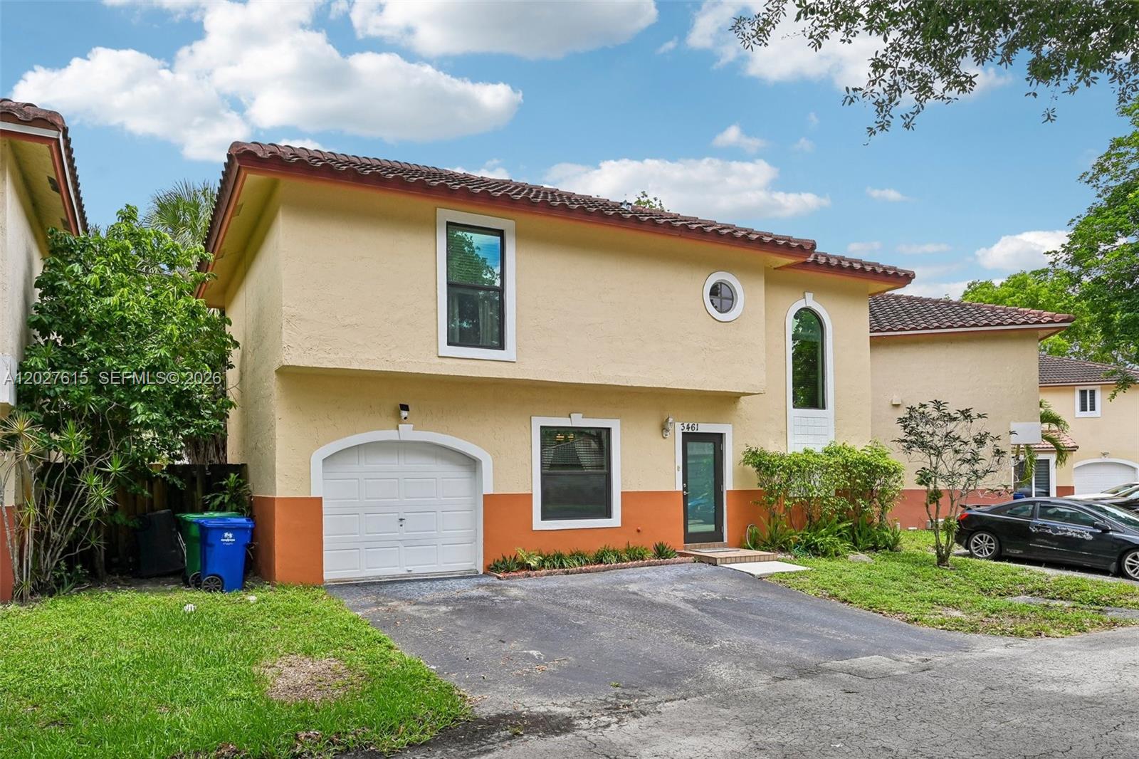 A two-story stucco house features a single-car garage, a driveway, and a tiled roof — 3461 Cluster Rd, Miramar FL 33025, MIRAMAR, FL