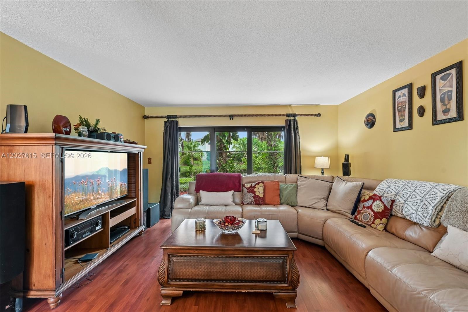 A living room features a large sectional sofa, a wooden coffee table, and a media console — 3461 Cluster Rd, Miramar FL 33025, MIRAMAR, FL