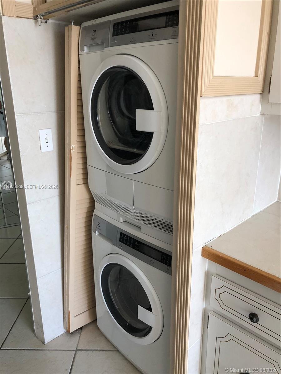A stacked Electrolux washer and dryer unit is installed in a tiled laundry closet — 2751 S Ocean Dr # 701N, Hollywood FL 33019, HOLLYWOOD, FL