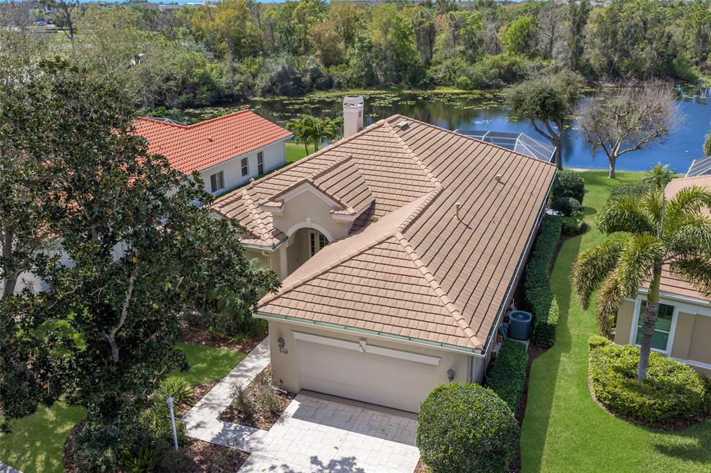An aerial view of a single-story house with a tan tile roof and garage — 8428 MISTY MORNING COURT, LAKEWOOD RANCH, FL