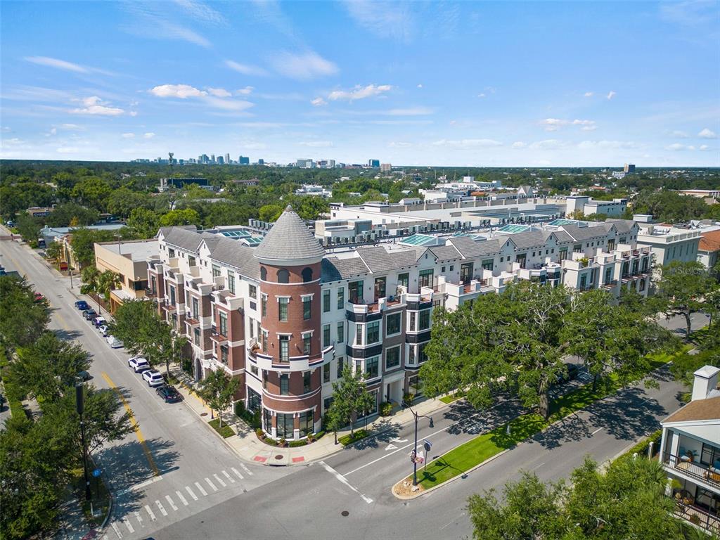 An aerial view shows a multi-story brick and white building with a prominent corner turret — 101 S NEW YORK AVENUE UNIT 311, WINTER PARK, FL