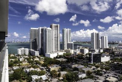 An elevated view of a city skyline featuring multiple high-rise buildings near a body of water — 121 NE 34th St # 2601, Miami FL 33137, MIAMI, FL