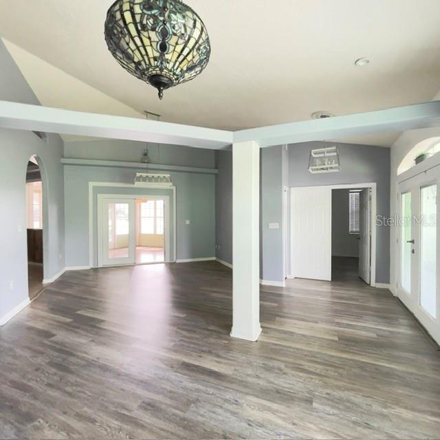 An open-concept living area features light gray walls, wood-look flooring, and a decorative stained-glass pendant — 259 NORWALK CIRCLE, EAGLE LAKE, FL