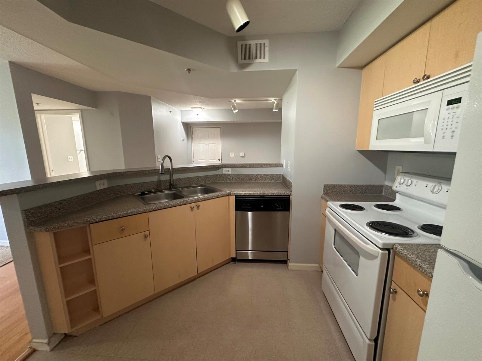 A kitchen with light wood cabinets, granite countertops, and white appliances — 3628 NW Adriatic Lane, Jensen Beach FL 34957, JENSEN BEACH, FL