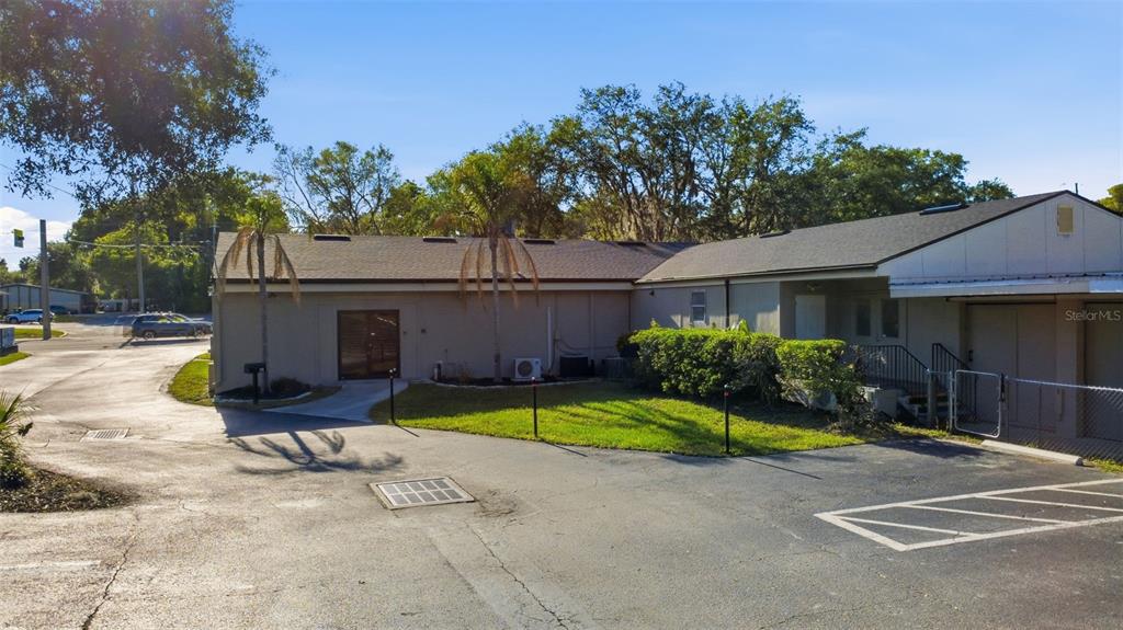 A single-story commercial building with a paved parking lot and two palm trees — 346 N VOLUSIA AVENUE, ORANGE CITY, FL
