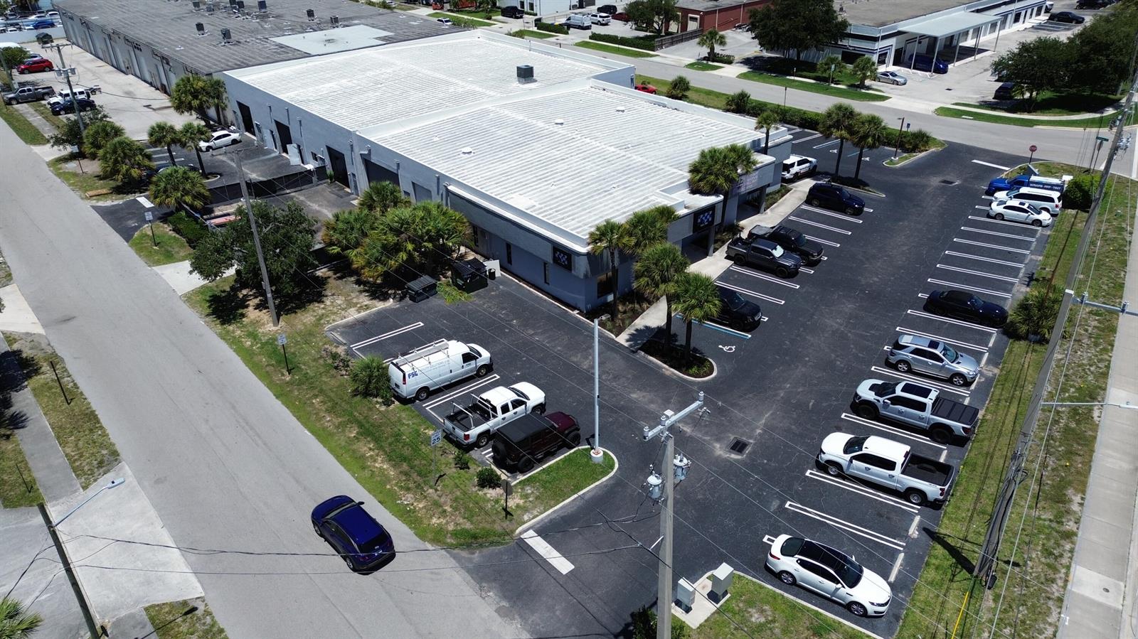 An aerial view shows a commercial building with a parking lot and surrounding streets — 1300 Old Dixie Highway # 108, Lake Park FL 33403, LAKE PARK, FL
