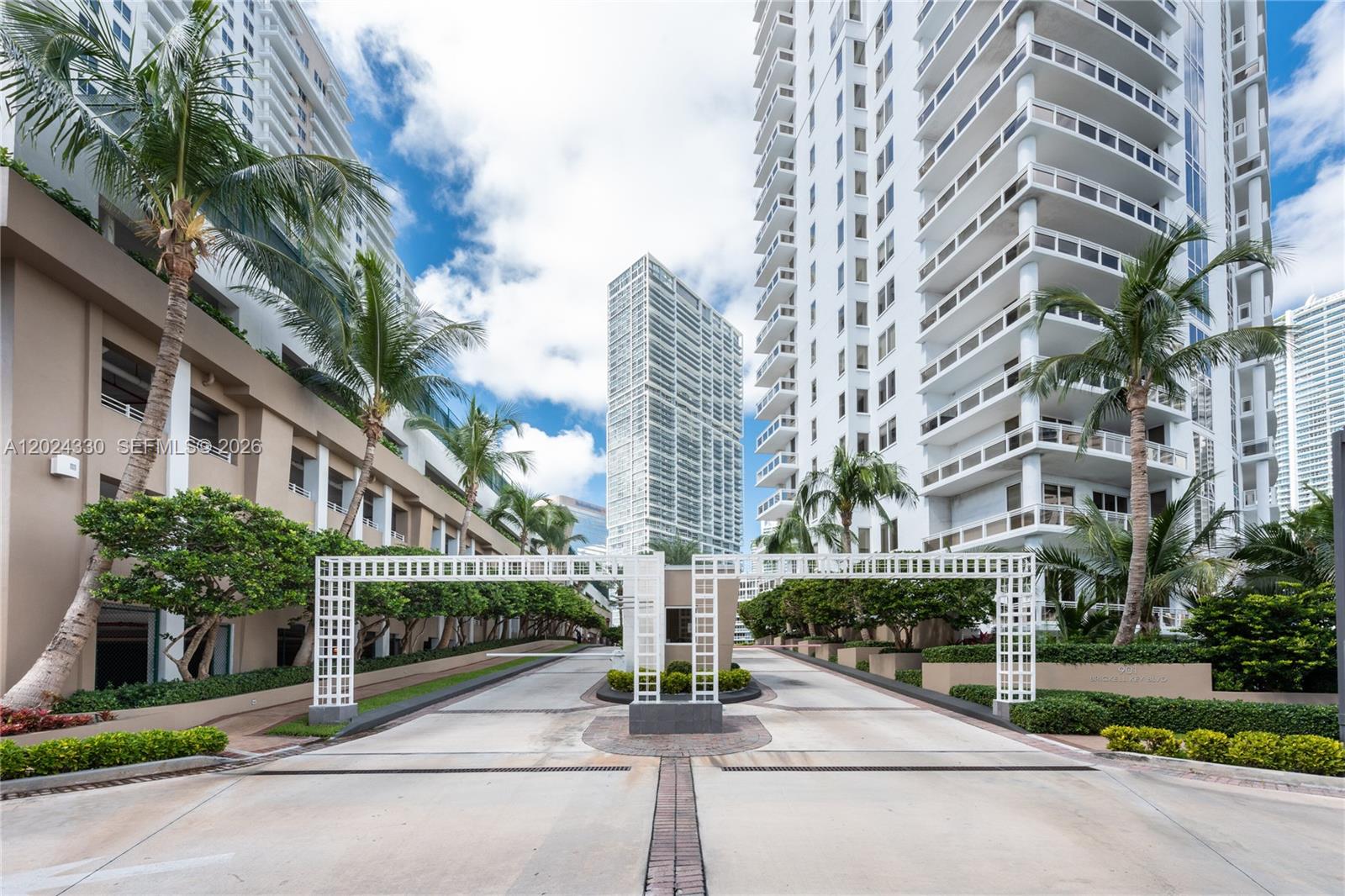 An aerial view of a canal surrounded by modern high-rise buildings in a city — 901 Brickell Key Blvd # 2006, Miami FL 33131, MIAMI, FL