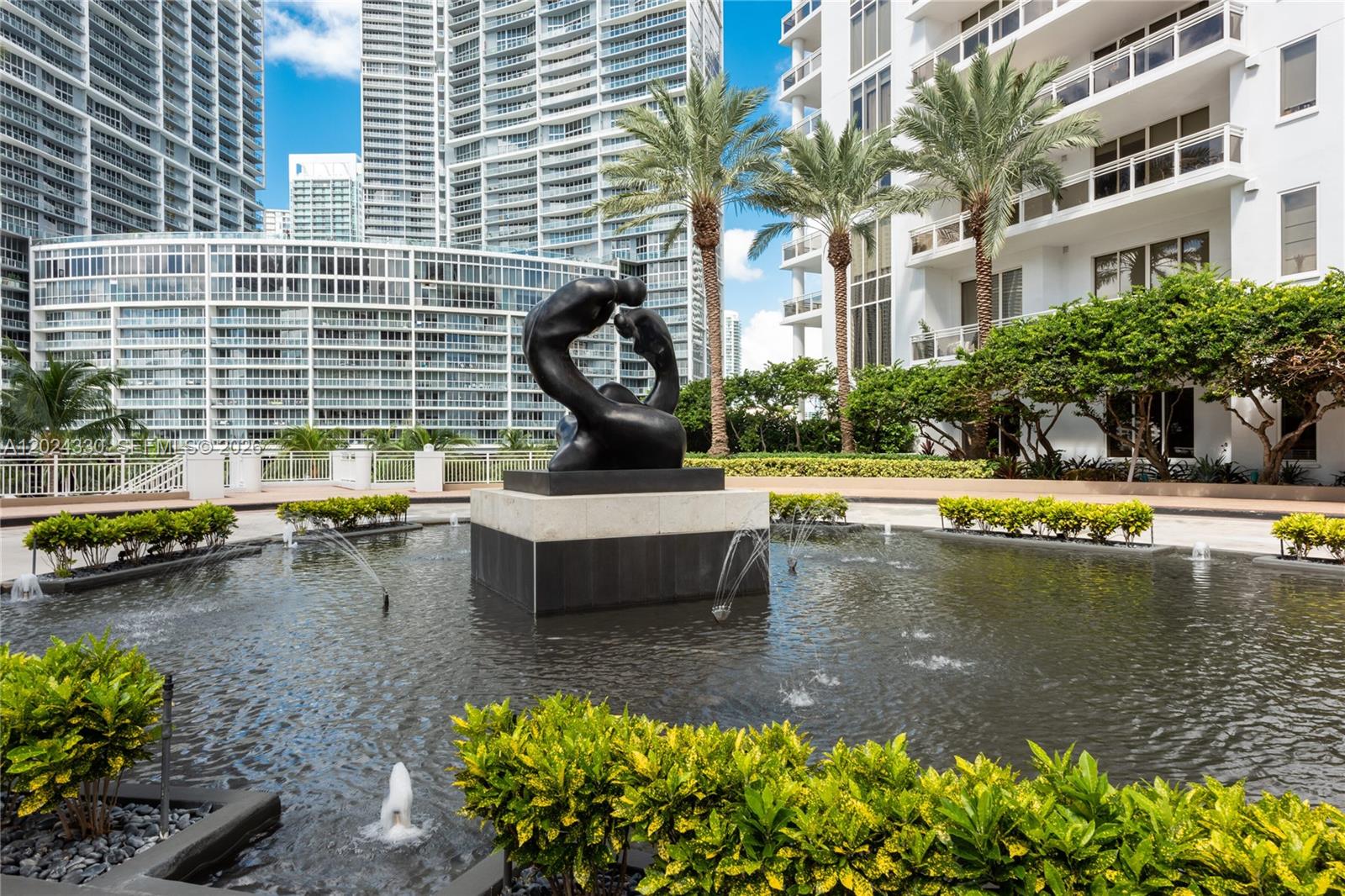 An aerial view shows high-rise buildings along a waterfront with boats in the bay — 901 Brickell Key Blvd # 2006, Miami FL 33131, MIAMI, FL