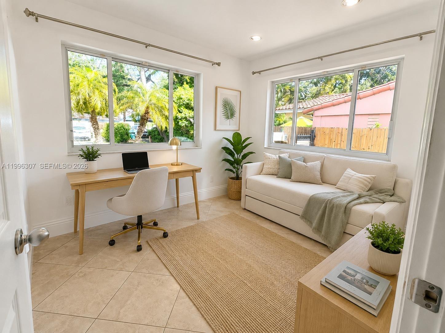 A bright home office features a desk, sofa, tile flooring, and two large windows — 4190 Pamona Ave # 0, Miami FL 33133, MIAMI, FL