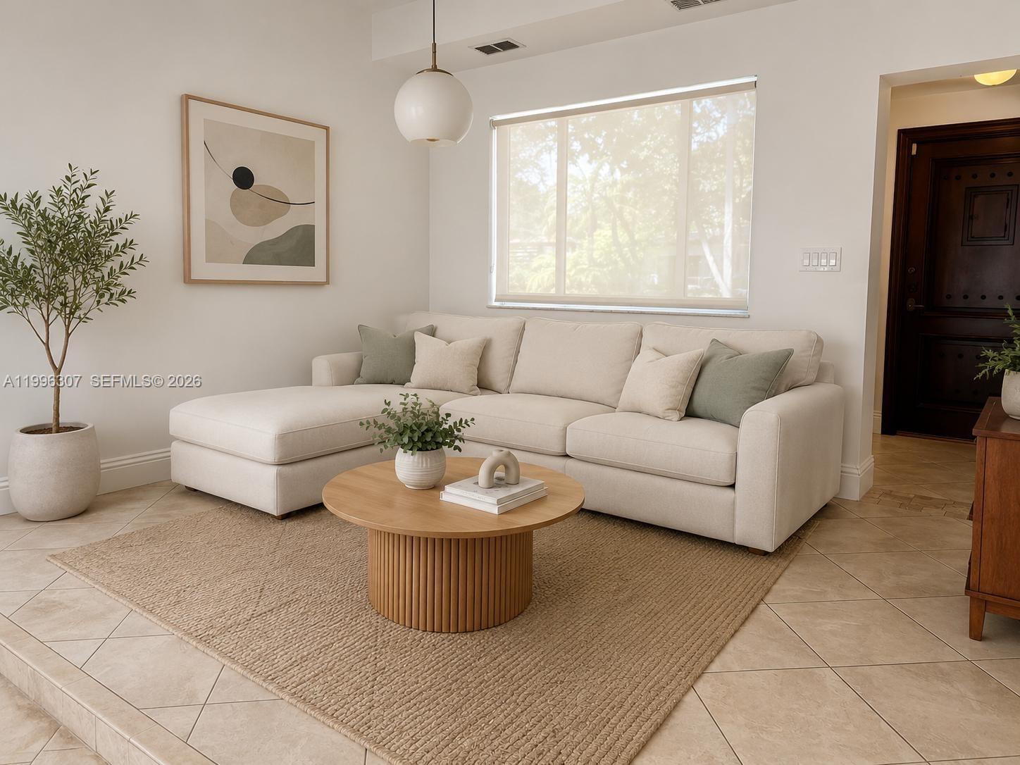 A living room features a beige sectional sofa, a round wooden coffee table, and a rug — 4190 Pamona Ave # 0, Miami FL 33133, MIAMI, FL