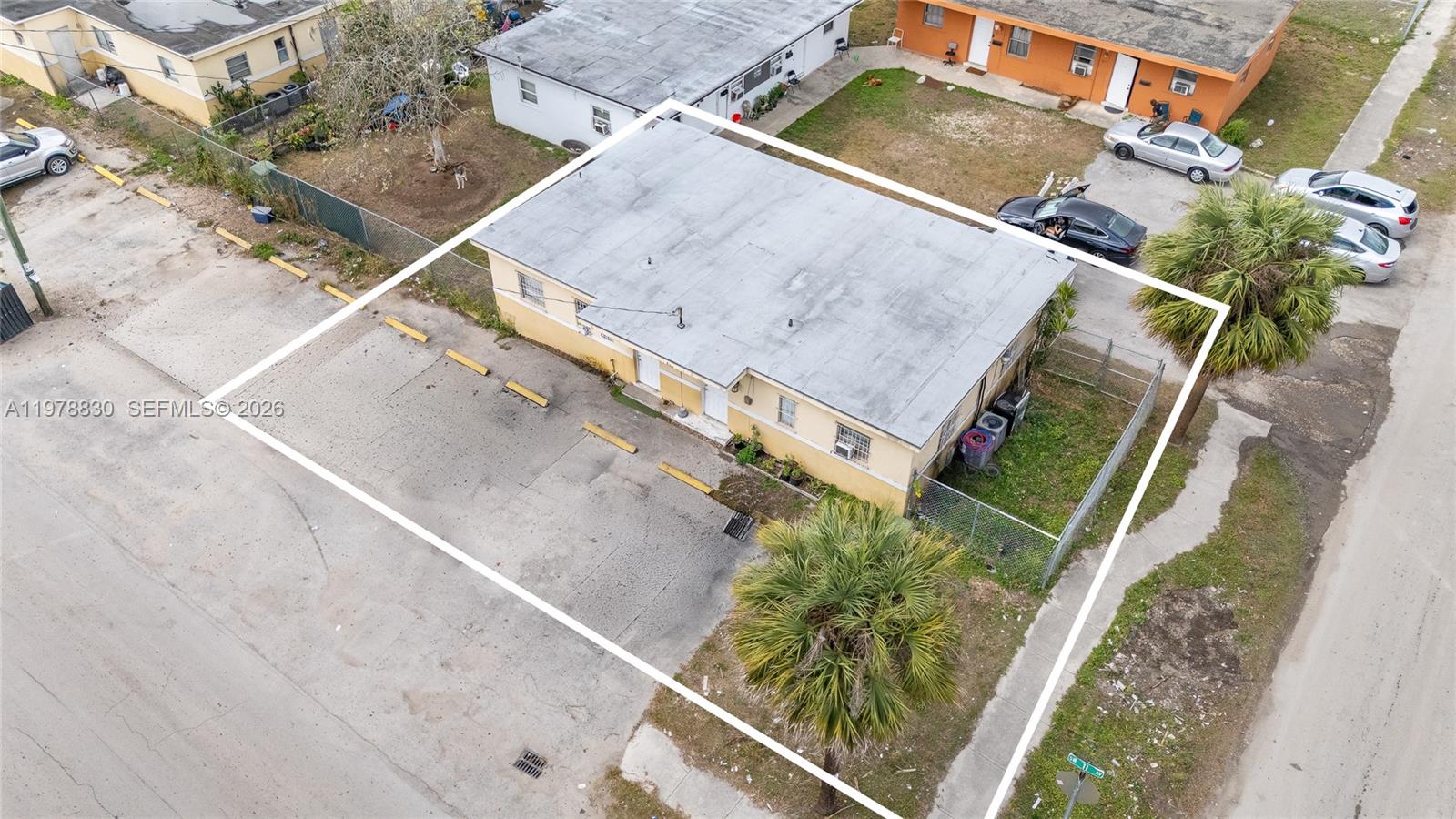 An aerial view shows a rectangular building with a flat roof and a parking lot — 1101 SW 2nd St, Homestead FL 33030, HOMESTEAD, FL