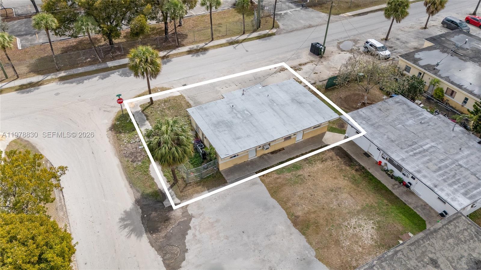 An aerial view shows a single-story house with a flat roof on a corner lot — 1101 SW 2nd St, Homestead FL 33030, HOMESTEAD, FL
