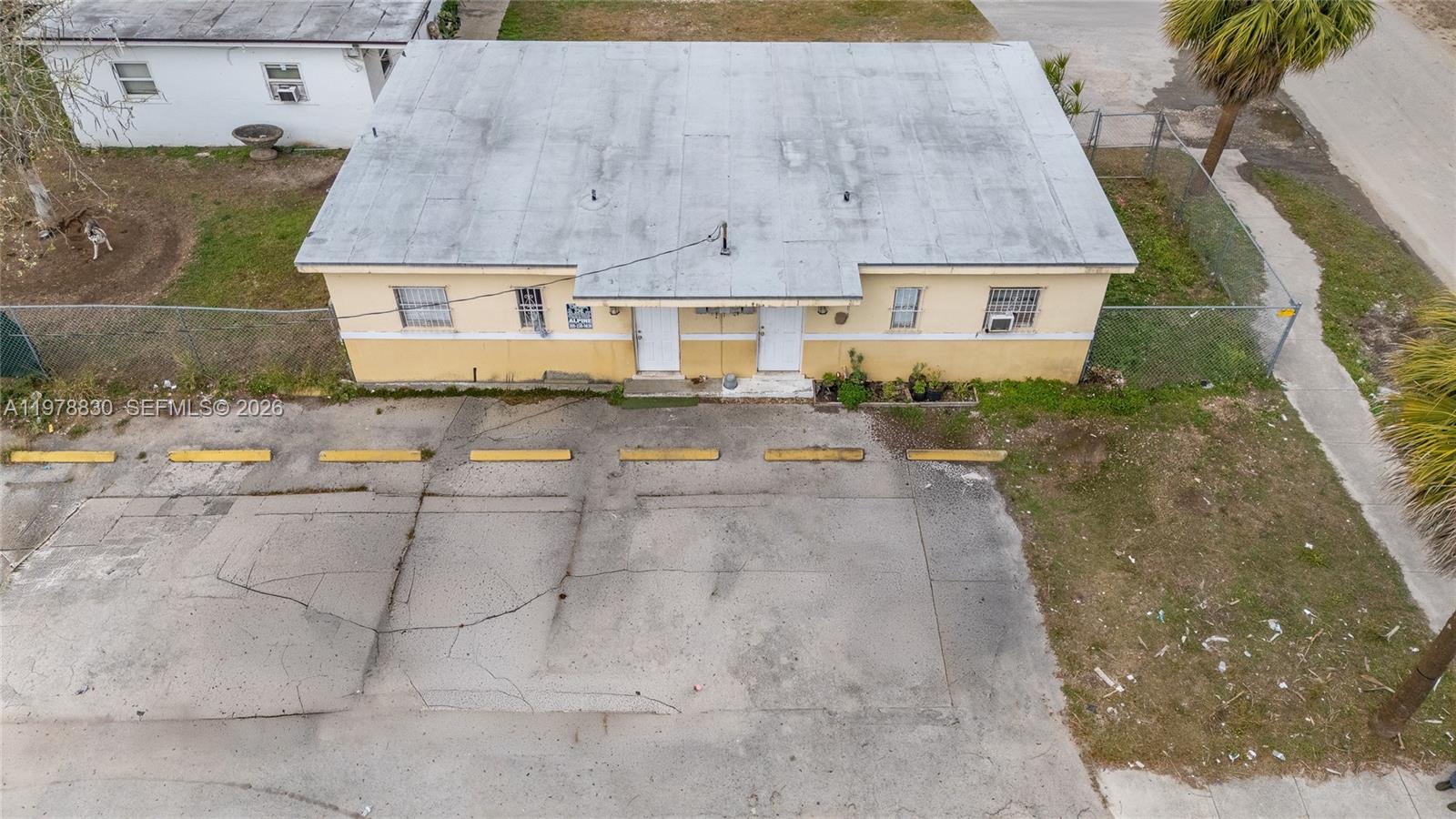 An aerial view shows a single-story duplex building with a flat roof and parking lot — 1101 SW 2nd St, Homestead FL 33030, HOMESTEAD, FL