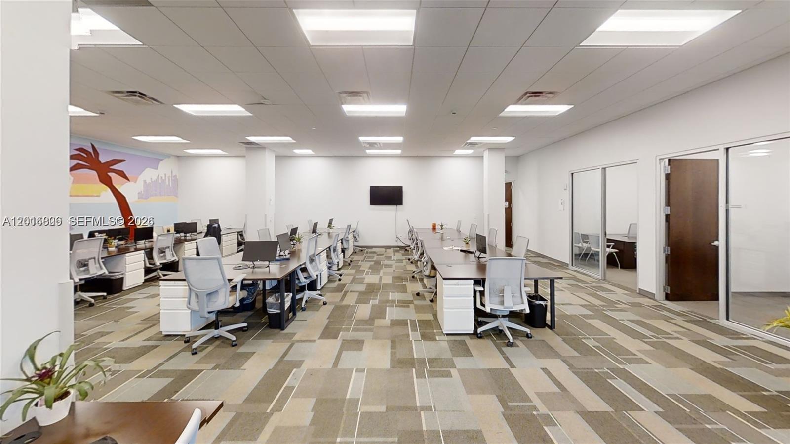 This office space features rows of desks, rolling chairs, and a patterned carpeted floor — 1501 Biscayne # 501, Miami FL 33132, MIAMI, FL