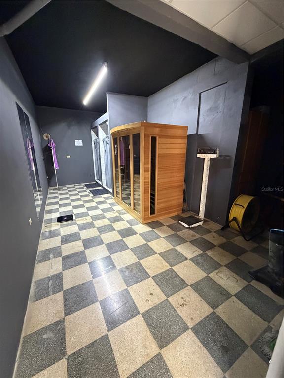 A room with a checkered floor contains a wooden sauna, a scale, and shower stalls — 158 CALLE PROGRESO, AGUADILLA, PR