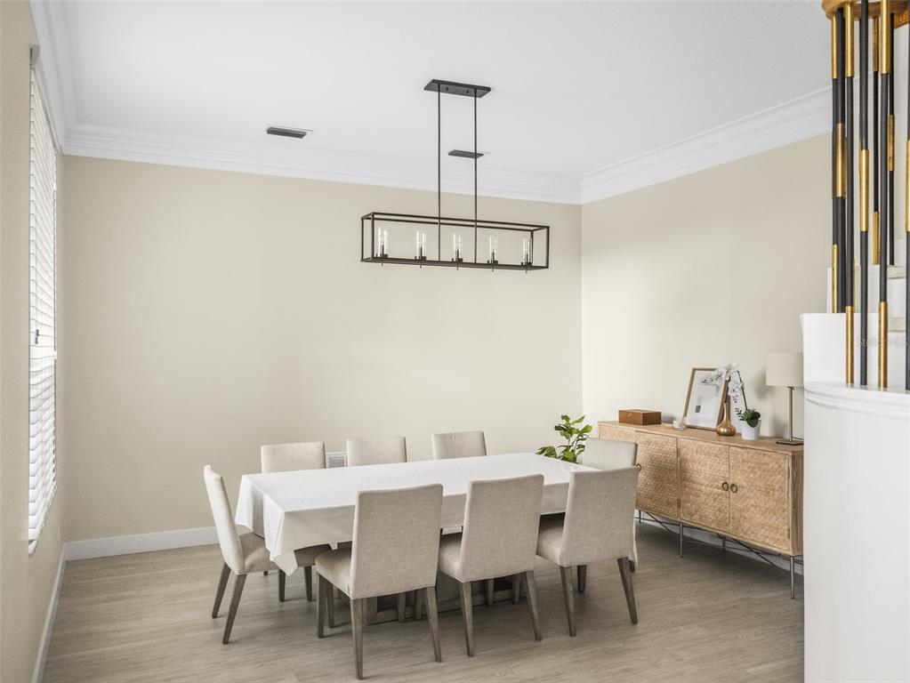 A dining room features a rectangular table with eight chairs, a sideboard, and a pendant light — 10550 LAKE MINNEOLA SHORES, CLERMONT, FL