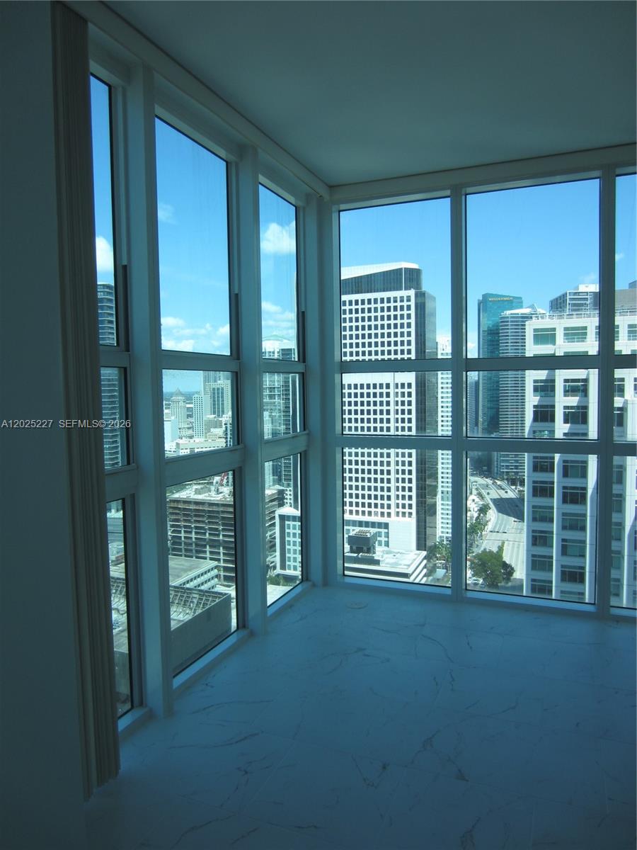 A room with white marble-style flooring and floor-to-ceiling windows overlooking a city skyline — 951 BRICKELL AV # 3401, Miami FL 33131, MIAMI, FL