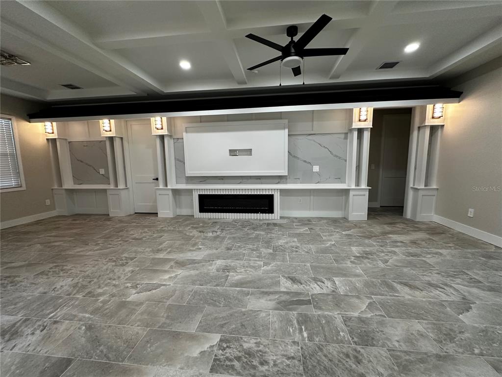 A living room features a coffered ceiling, tile flooring, and a built-in fireplace wall — 44 KEEBLE AVENUE, DEBARY, FL