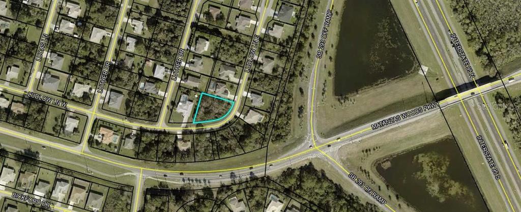 This is an aerial map view showing a vacant residential lot outlined in light blue — 13 LUDLOW LANE E, PALM COAST, FL