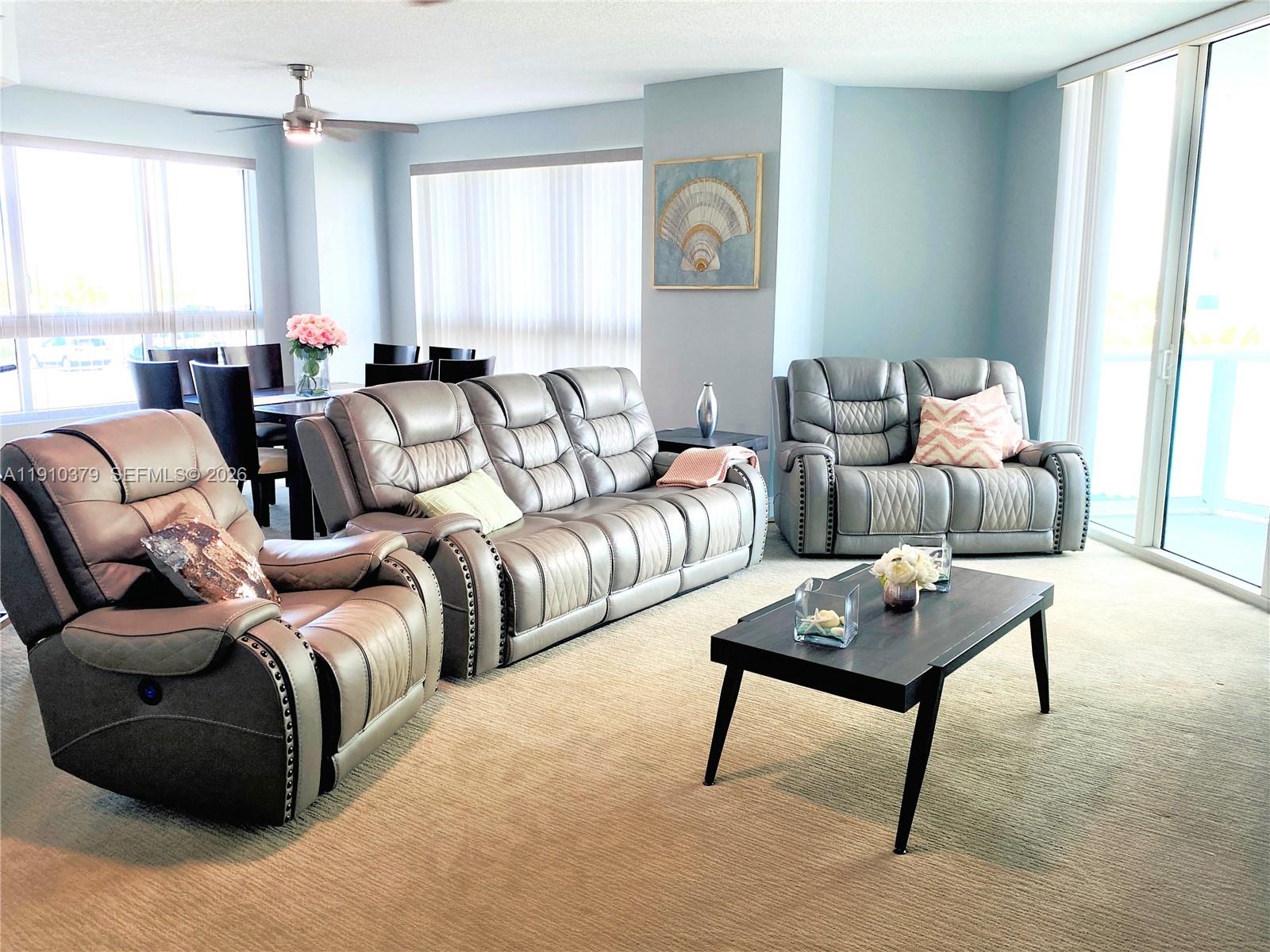 A bedroom features a white tufted bed, a pink throw, and a mirrored dresser — 231 Riverside Dr # 510, Daytona FL 32117, DAYTONA, FL
