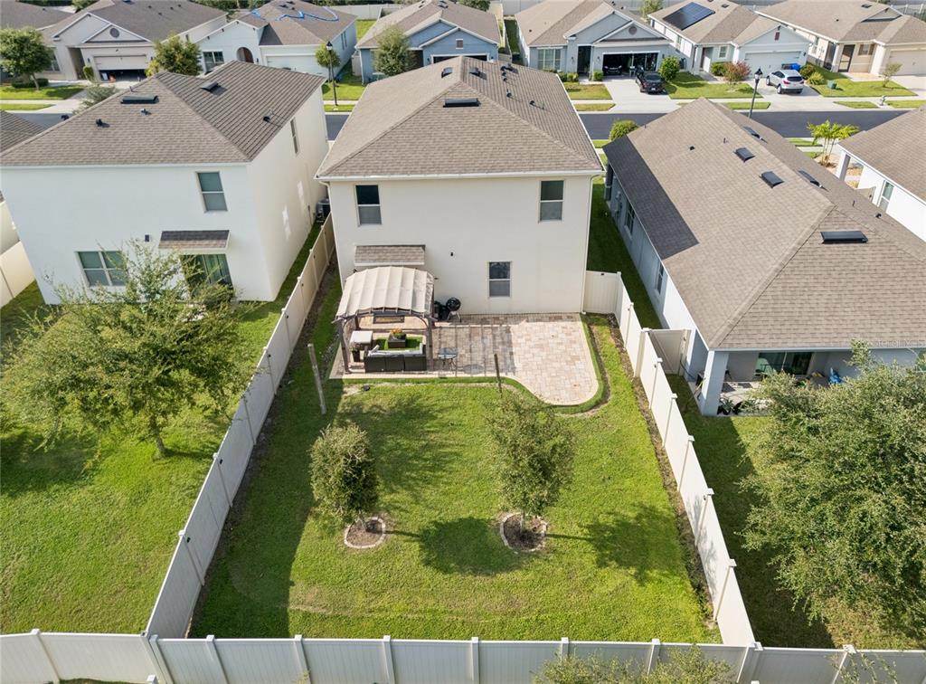 An aerial view shows the backyard of a two-story house with a patio and gazebo — 3057 TIMBER HAWK CIRCLE, OCOEE, FL