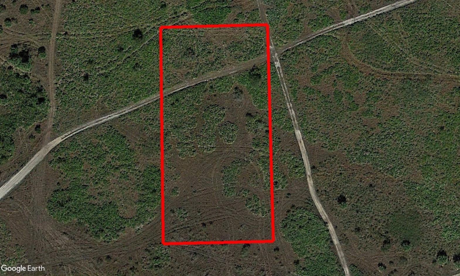 An aerial view of a rectangular plot of land outlined in red on grassy terrain — 0 NW 310th Street, Okeechobee FL 34972, OKEECHOBEE, FL