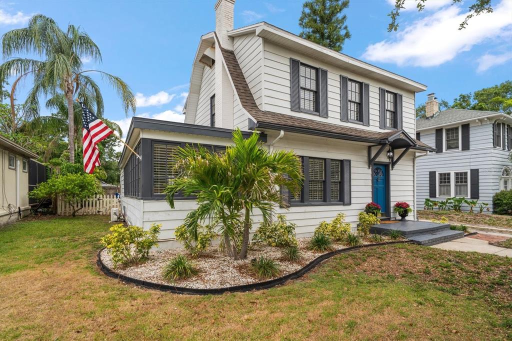 A two-story white house with dark shutters, a blue front door, and a front yard — 310 N LINCOLN AVENUE, CLEARWATER, FL