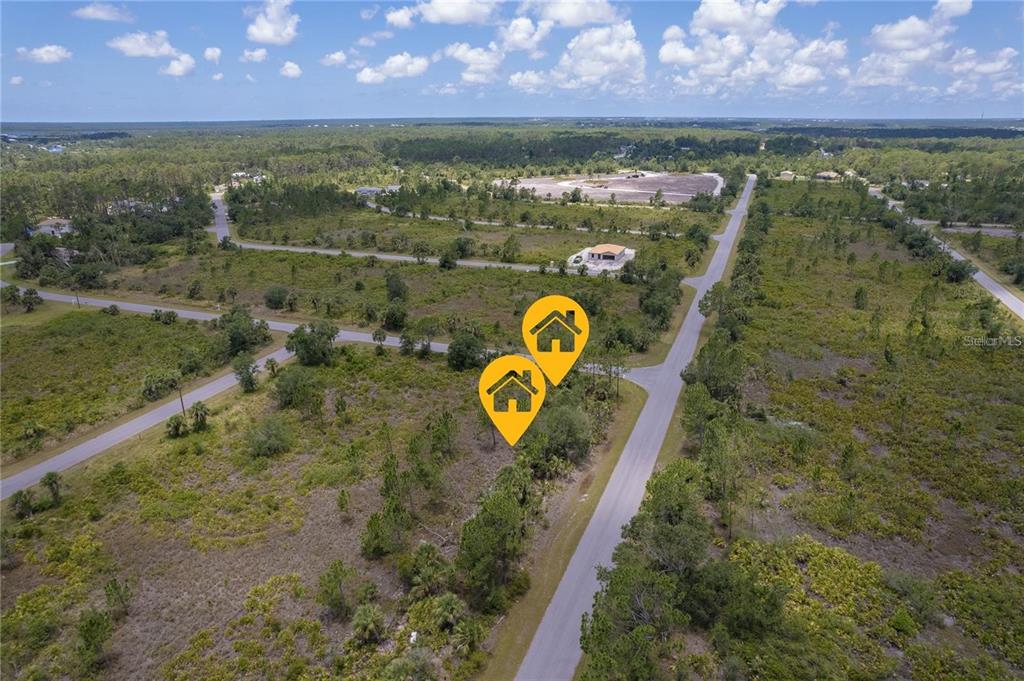An aerial view shows two adjacent vacant lots marked with house icons along a paved road — 218 GASTIN STREET, PORT CHARLOTTE, FL