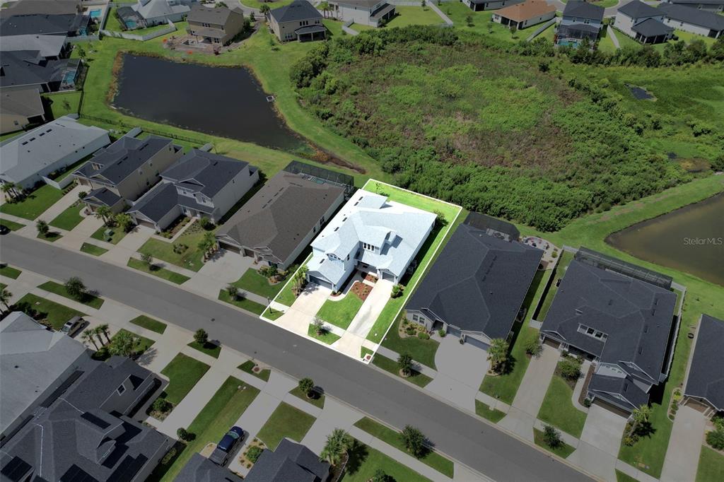 An aerial view shows a single-family home highlighted in white within a suburban neighborhood — 7201 TALAMORE DRIVE, WESLEY CHAPEL, FL
