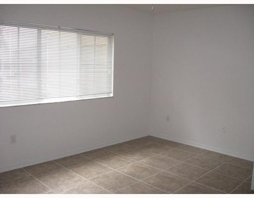 An empty room with white walls, tiled flooring, and a window with horizontal blinds — 2421 Centergate Drive # 104, Miramar FL 33025, MIRAMAR, FL