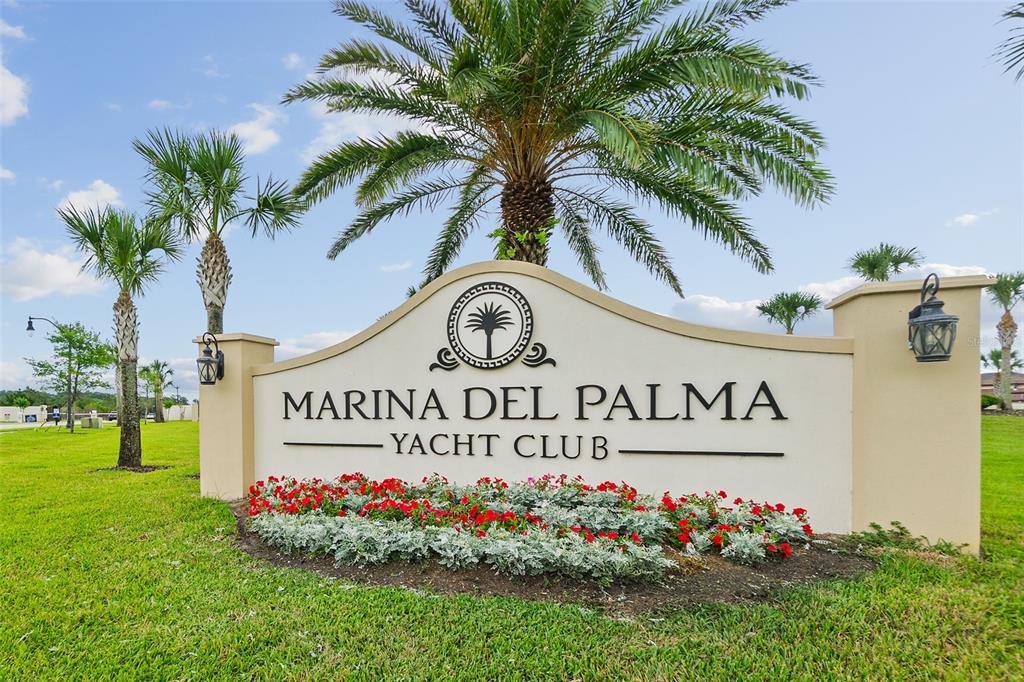 A beige monument sign for Marina Del Palma Yacht Club sits in a grassy yard — 14 RIO VISTA DRIVE, PALM COAST, FL