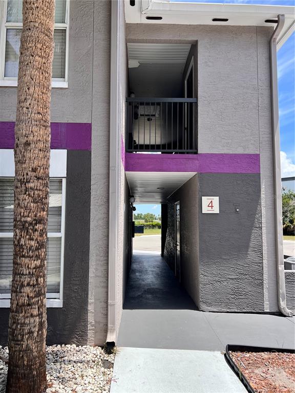 An exterior view shows a building entrance with a walkway, a balcony, and unit number four — 3100 PARKWAY BOULEVARD UNIT 417, KISSIMMEE, FL
