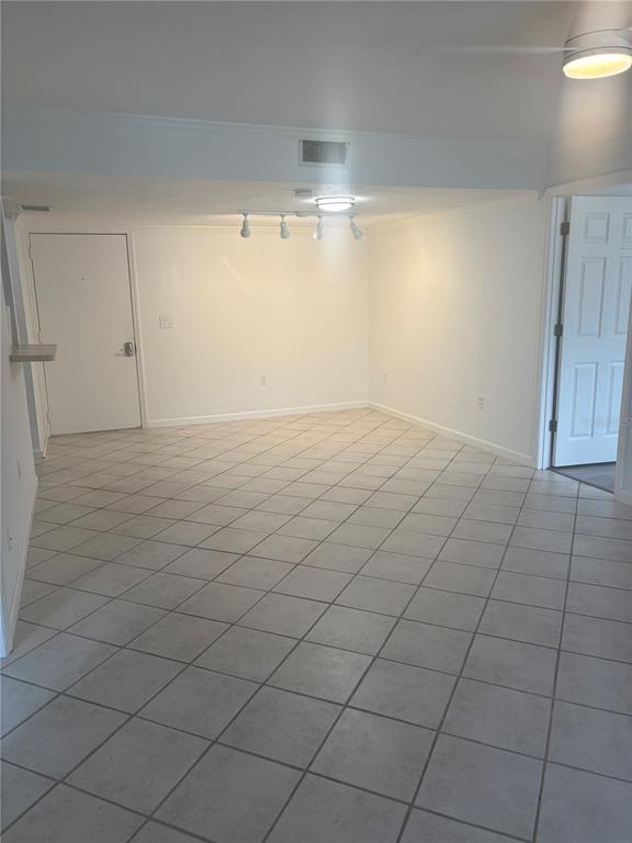 An empty room with white walls, tiled floors, a ceiling fan, and track lighting — 503 ALBEE FARM ROAD UNIT B28, VENICE, FL