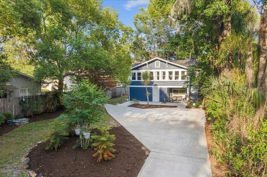 A two-story blue house with a concrete driveway and surrounding trees and landscaping — 1209 S MYRTLE AVENUE UNIT A, SANFORD, FL