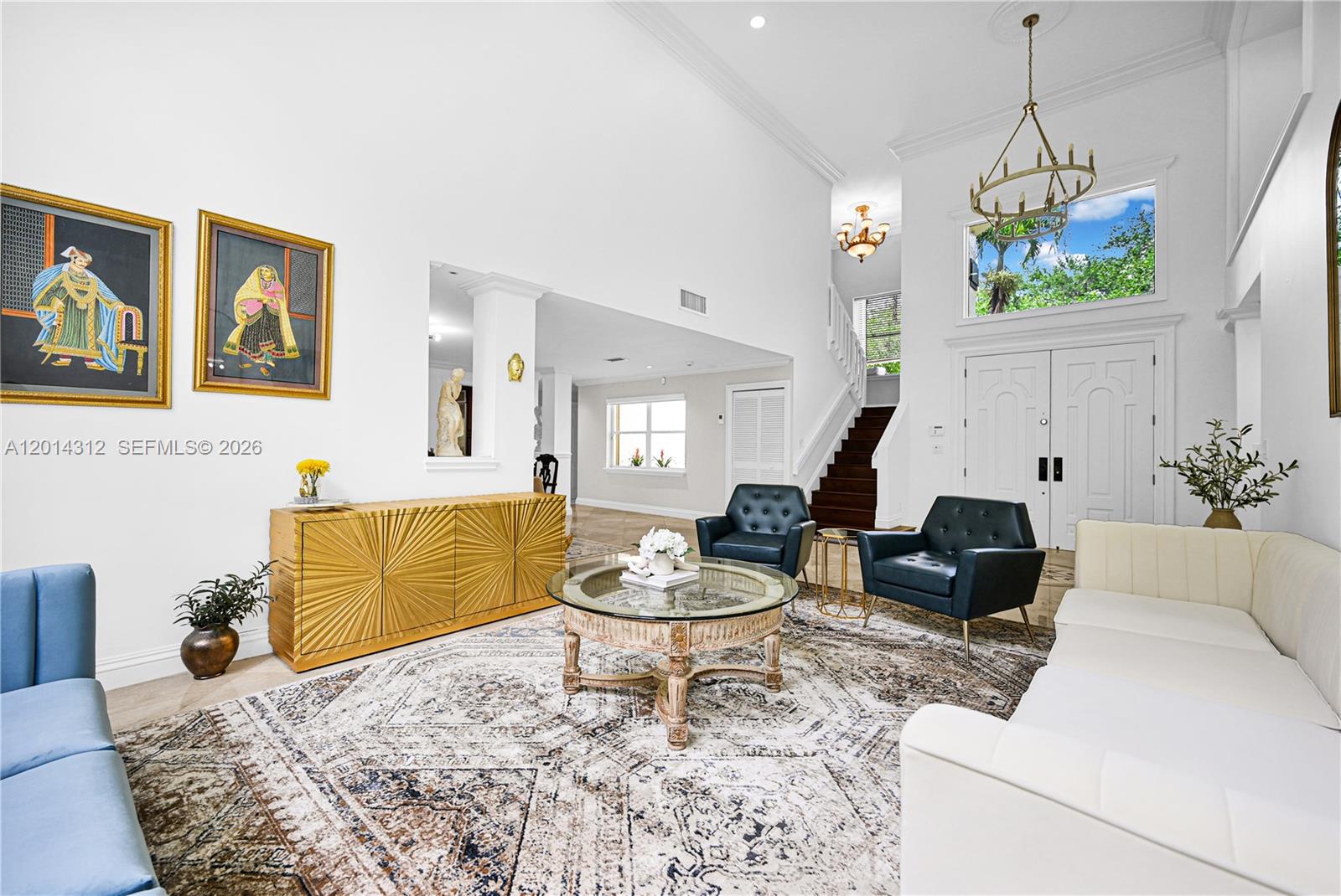 A high-ceilinged living room features a white sofa, two dark armchairs, and a gold sideboard — 9866 SW 111th Ter # 9866, Miami FL 33176, MIAMI, FL