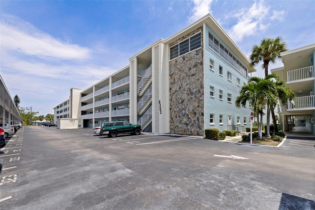 A multi-story apartment building with a stone facade and an outdoor staircase — 6363 GULF WINDS DRIVE UNIT 131, ST PETE BEACH, FL