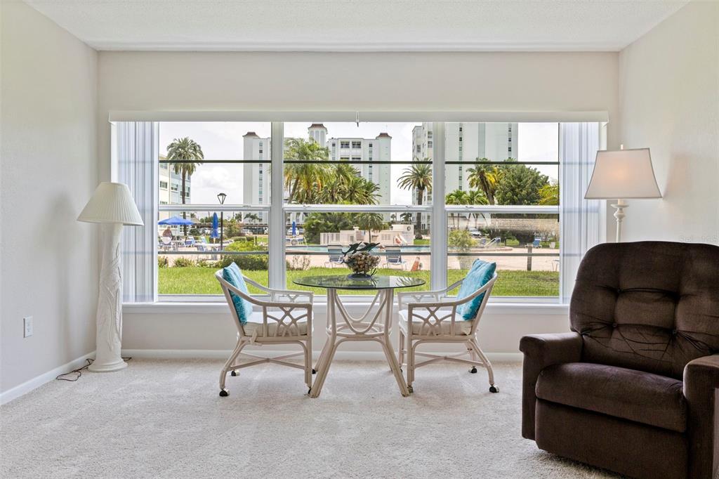 A blue exterior wall features a white storm door and windows along a paved walkway — 6363 GULF WINDS DRIVE UNIT 131, ST PETE BEACH, FL