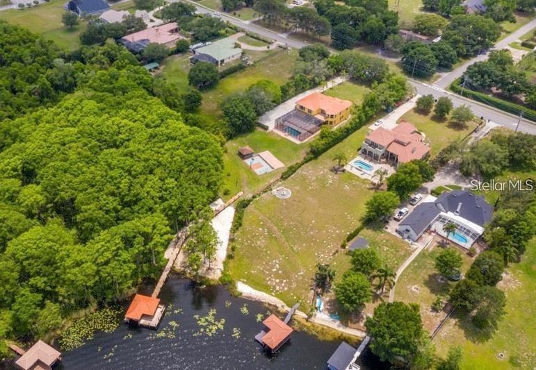 An aerial view shows several houses with swimming pools and private docks on a lake — 13161 LAKE BUTLER BOULEVARD, WINDERMERE, FL