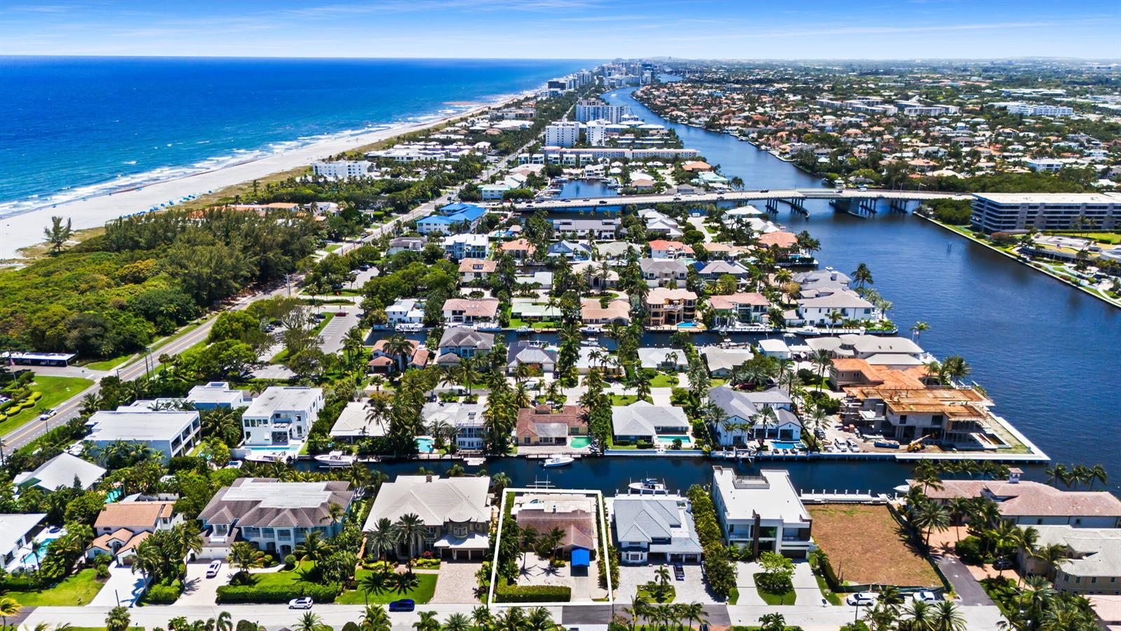 An aerial view of a coastal neighborhood featuring waterfront homes, canals, and a beach — 1018 Brooks Lane, Delray Beach FL 33483, DELRAY BEACH, FL