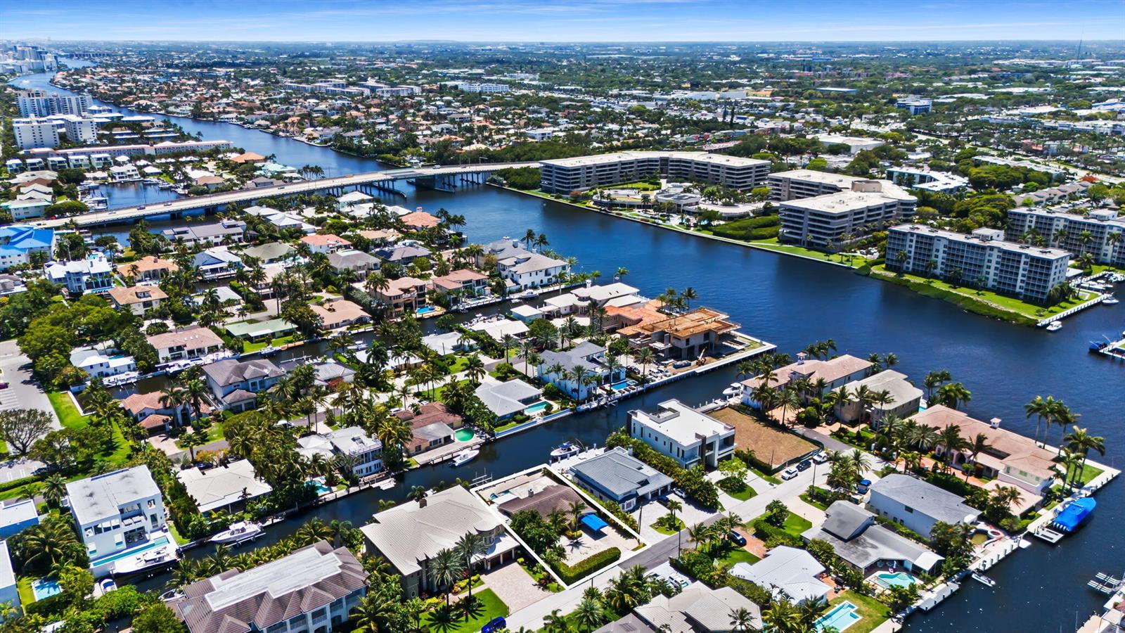 An aerial view shows waterfront homes and apartment buildings along a canal in Florida — 1018 Brooks Lane, Delray Beach FL 33483, DELRAY BEACH, FL