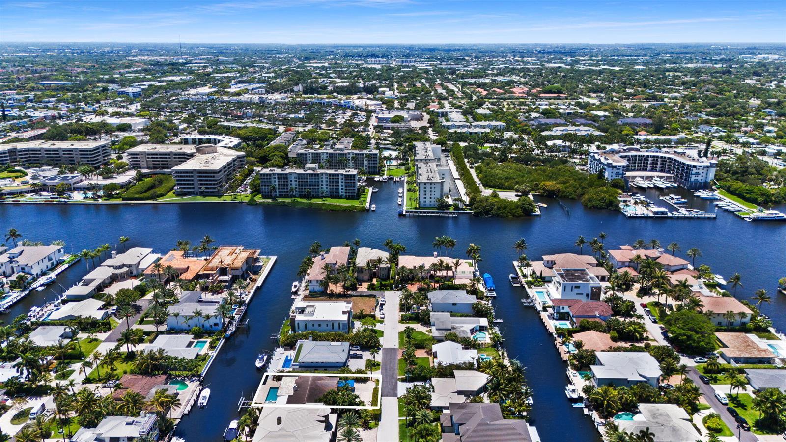 An aerial view shows a residential neighborhood with waterfront homes, canals, and apartment buildings — 1018 Brooks Lane, Delray Beach FL 33483, DELRAY BEACH, FL