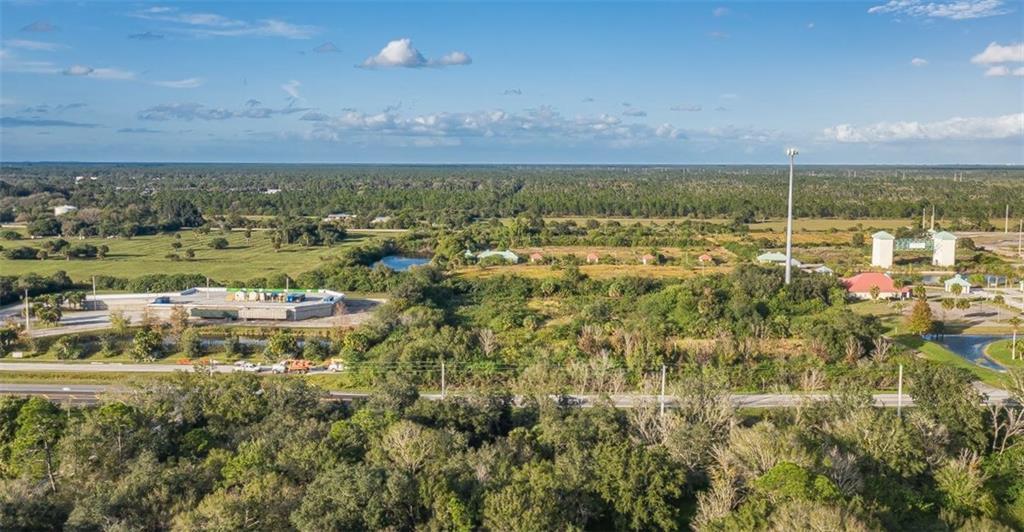 An aerial view shows a commercial building, a cell tower, and surrounding wooded land — 9555 Mesa Park Boulevard, Fellsmere FL 32948, FELLSMERE, FL